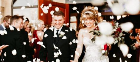 A couple coming out of the church after getting married