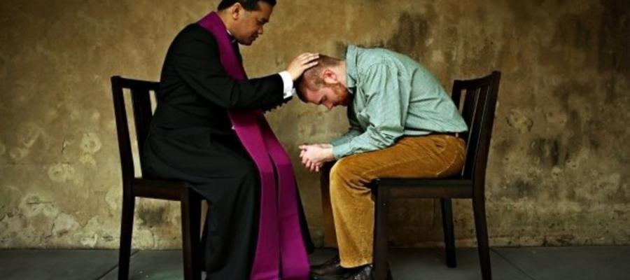 A priest hearing confession