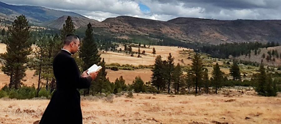 Father Brian in a field