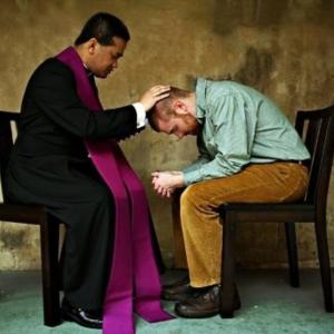 A priest hearing confession