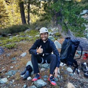 Father Brian taking a rest on a hike
