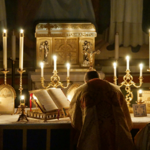 A Priest Offering Mass in Candlelight 