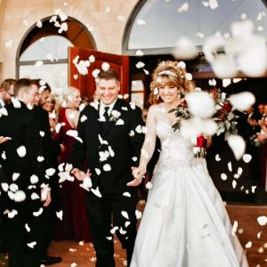 A couple coming out of the church after getting married