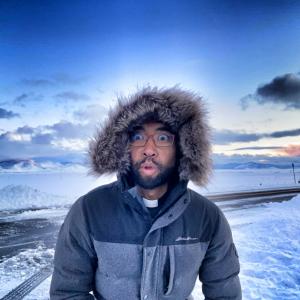 Father Brian in the snow making a silly face